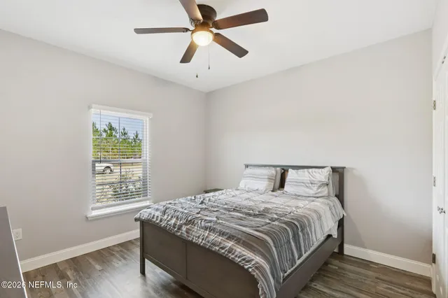 a bedroom with a bed and a ceiling fan