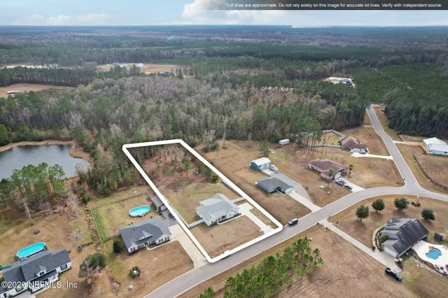 an aerial view of a house with pool lake view and mountain view