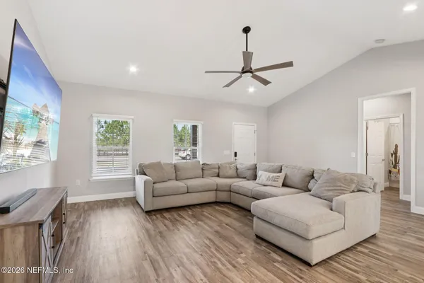 a living room with furniture and kitchen view