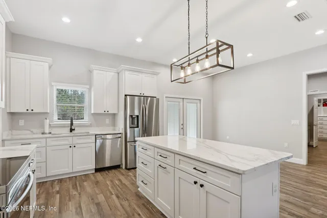 a kitchen with white cabinets and a sink
