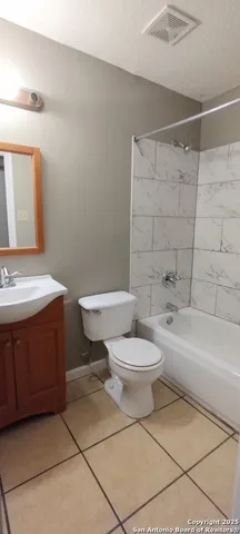 a bathroom with a toilet a sink and bathtub