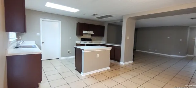 a utility room with cabinets washer and dryer