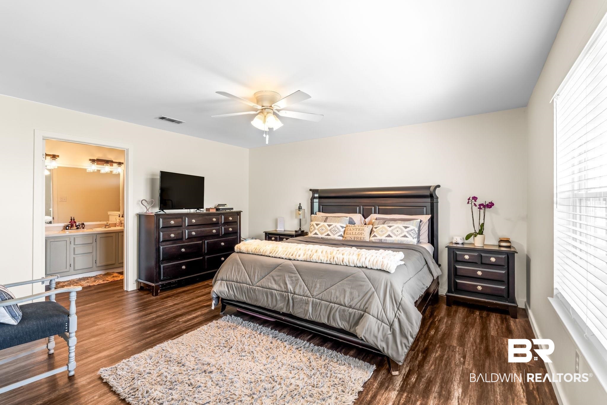 28475 Leiterman Road Elberta, AL 36530 - Photo 23 of 35 Bedroom with ensuite bathroom, visible vents, baseboards, ceiling fan, and dark wood-style floors