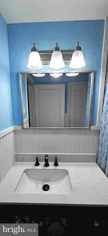 a view of kitchen with two sinks a stove and a clock