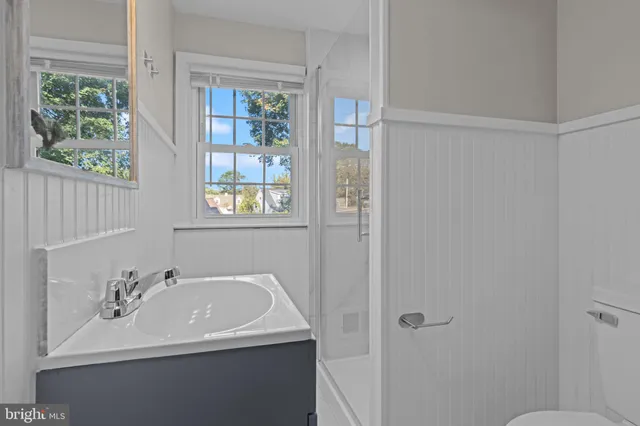 a bathroom with a sink toilet and a window