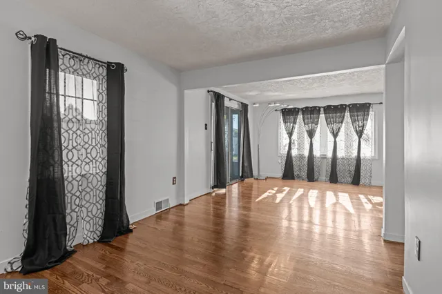 a view of wooden floor and windows in a room