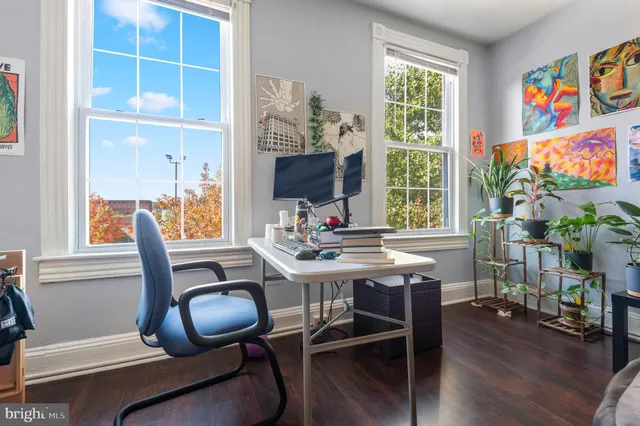 a view of a workspace with furniture and a window