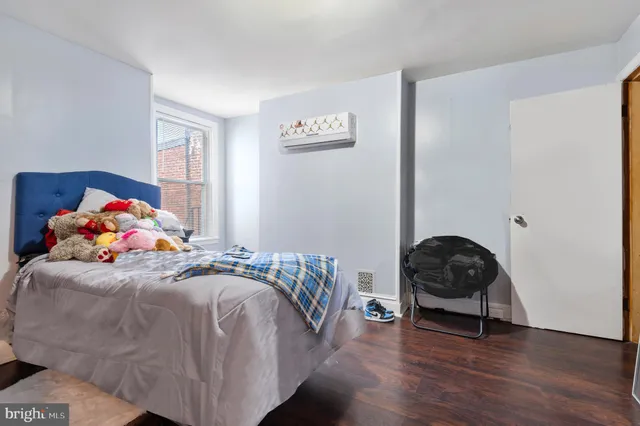 a bedroom with a bed and a chair