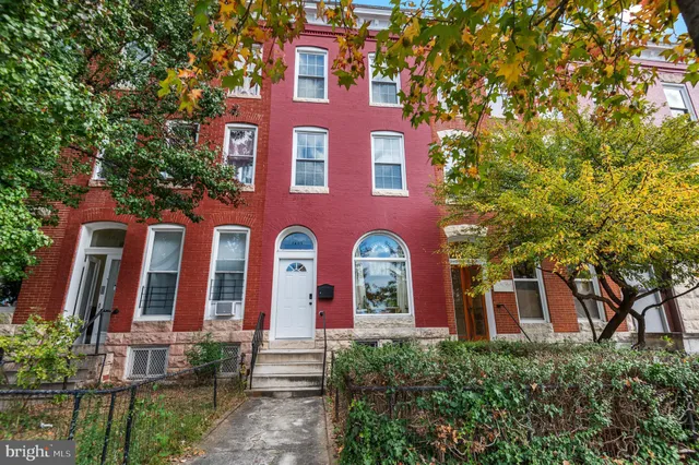 front view of a brick house with a large windows