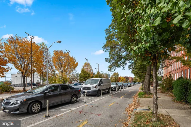 a view of cars parked on the side of a street