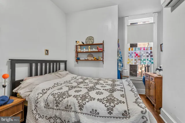 a bed sitting in a bedroom and a large window