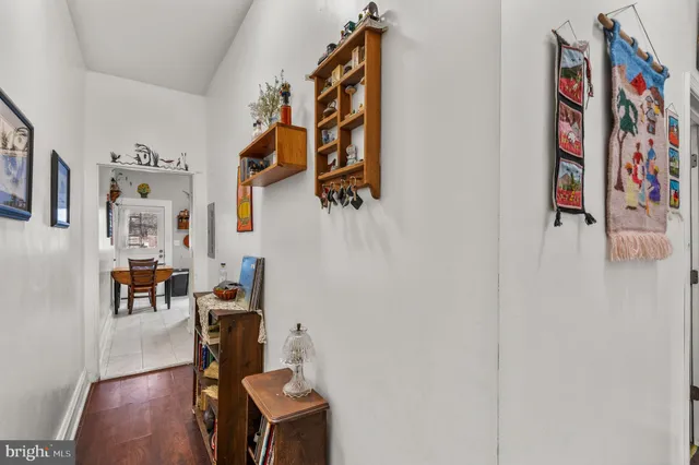 a living room with furniture and a book shelf