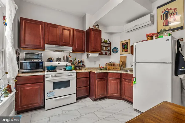 a kitchen with a refrigerator and a stove top oven