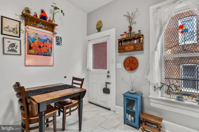 a room with furniture and paintings on the wall