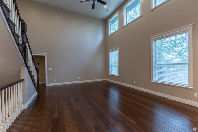 3565 West 1350th Street North Vernal, UT 84078 - Photo 10 of 54 Spacious living area featuring high ceilings, dark wood-finish flooring, and multiple windows with white blinds
