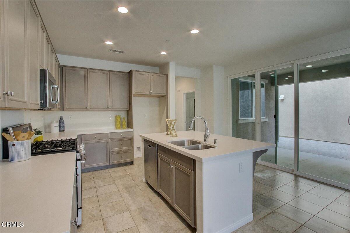 182 Stonegate Road Camarillo, CA 93010 - Photo 12 of 41 a kitchen with stainless steel appliances granite countertop a sink stove and refrigerator