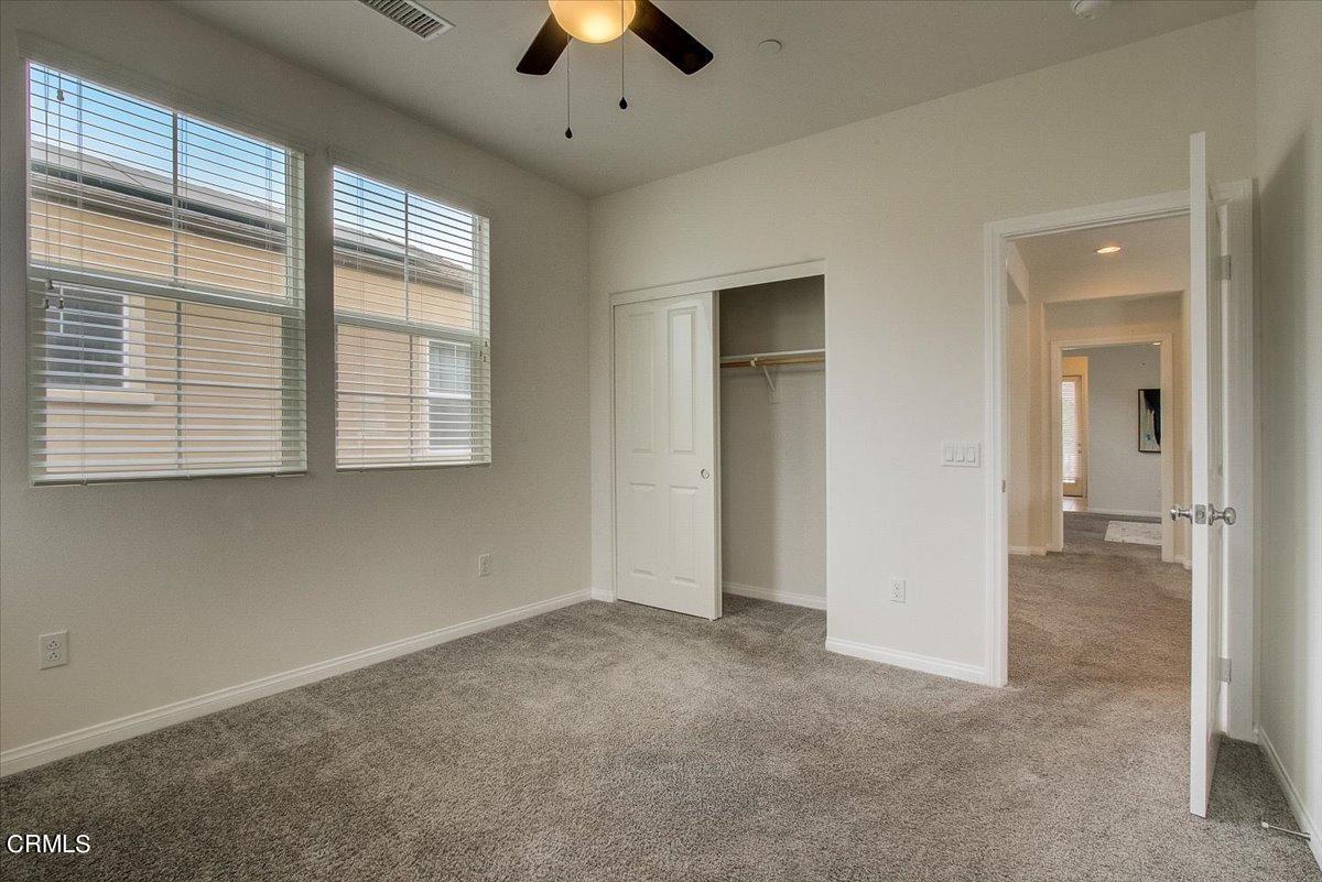 182 Stonegate Road Camarillo, CA 93010 - Photo 21 of 41 an empty room with chandelier fan and windows