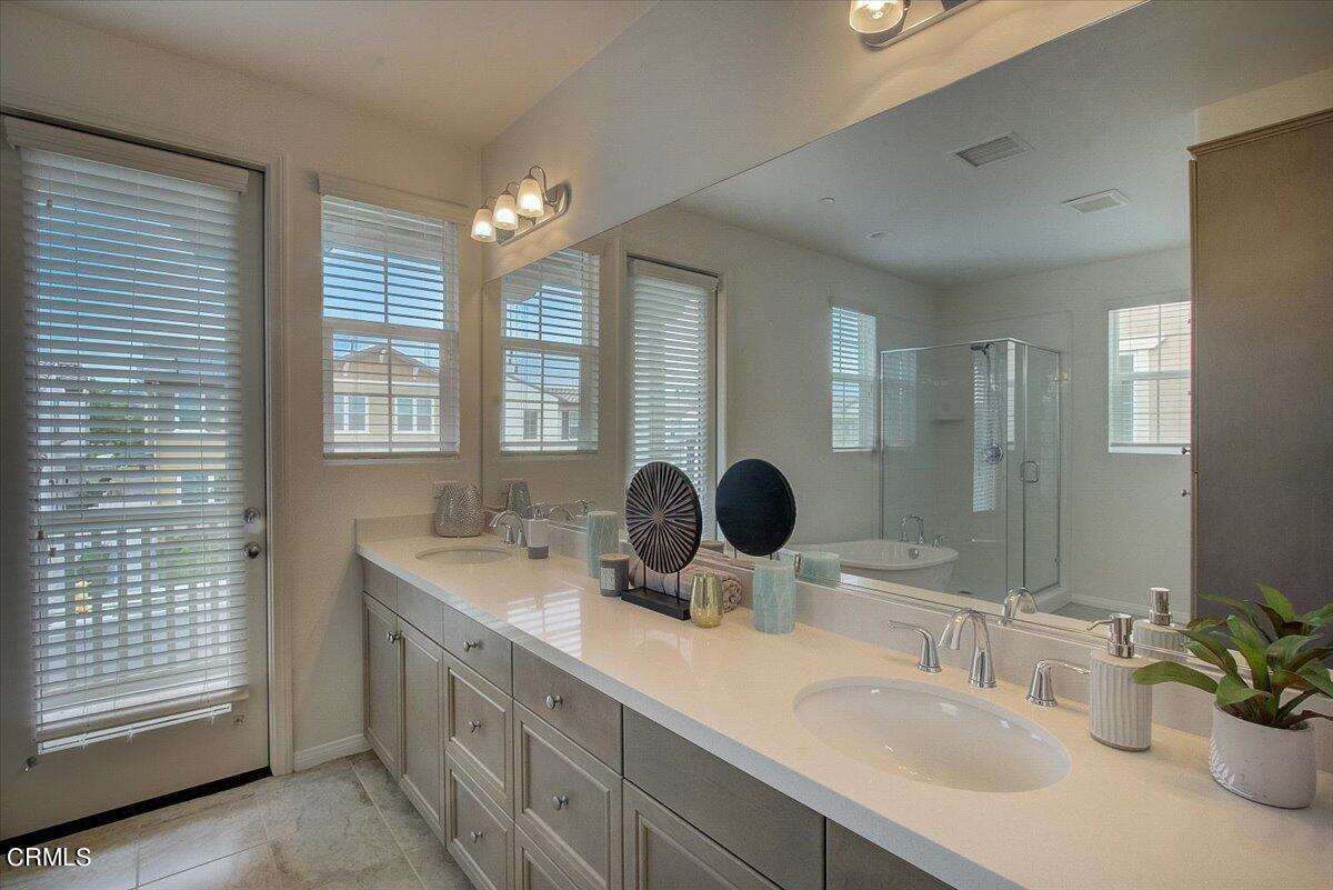 182 Stonegate Road Camarillo, CA 93010 - Photo 23 of 41 a bathroom with a double vanity sink a mirror and a shower
