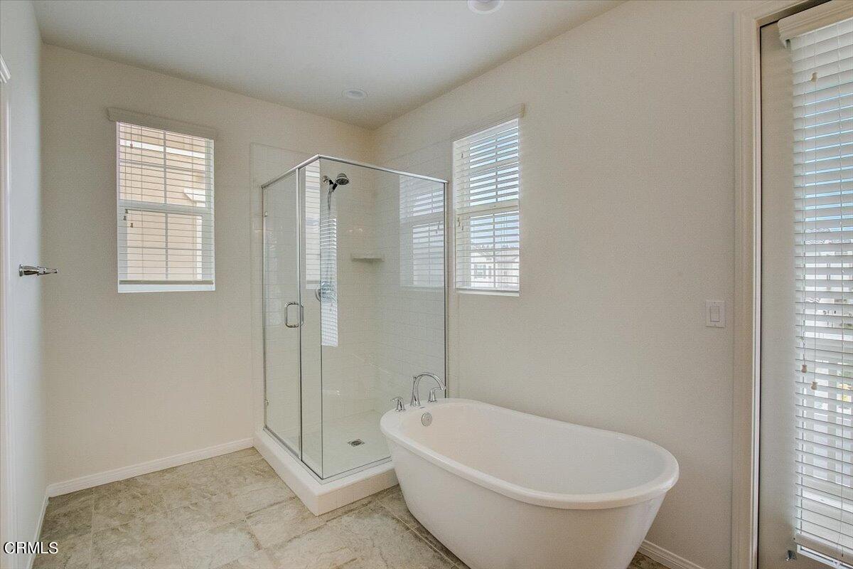 182 Stonegate Road Camarillo, CA 93010 - Photo 24 of 41 a spacious bathroom with a bathtub and shower
