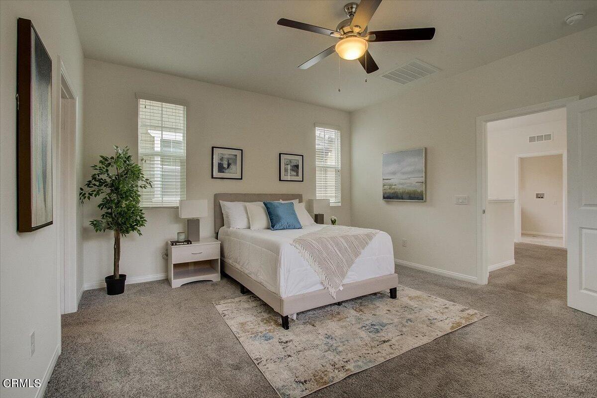 182 Stonegate Road Camarillo, CA 93010 - Photo 25 of 41 a bed room with a bed and a chandelier