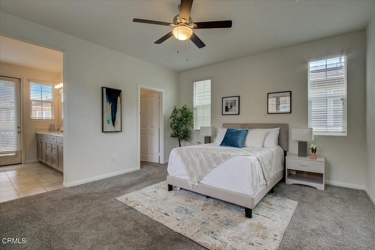 182 Stonegate Road Camarillo, CA 93010 - Photo 26 of 41 a spacious bedroom with a bed painting on wall and windows