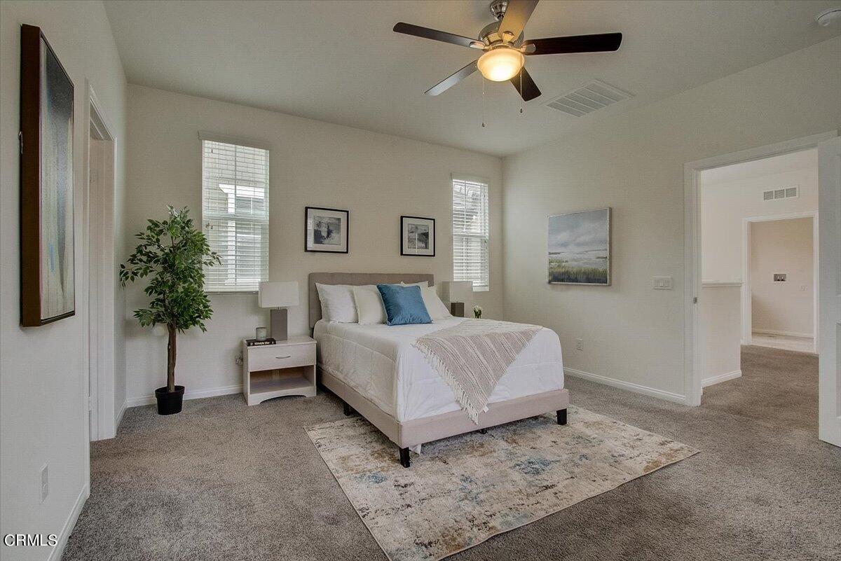 182 Stonegate Road Camarillo, CA 93010 - Photo 27 of 41 a bed room with a bed and a chandelier
