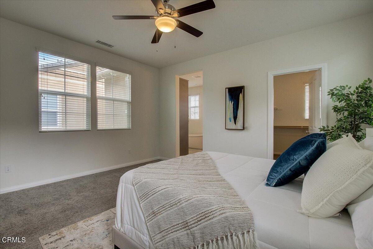 182 Stonegate Road Camarillo, CA 93010 - Photo 28 of 41 a bedroom with a large bed and a chandelier