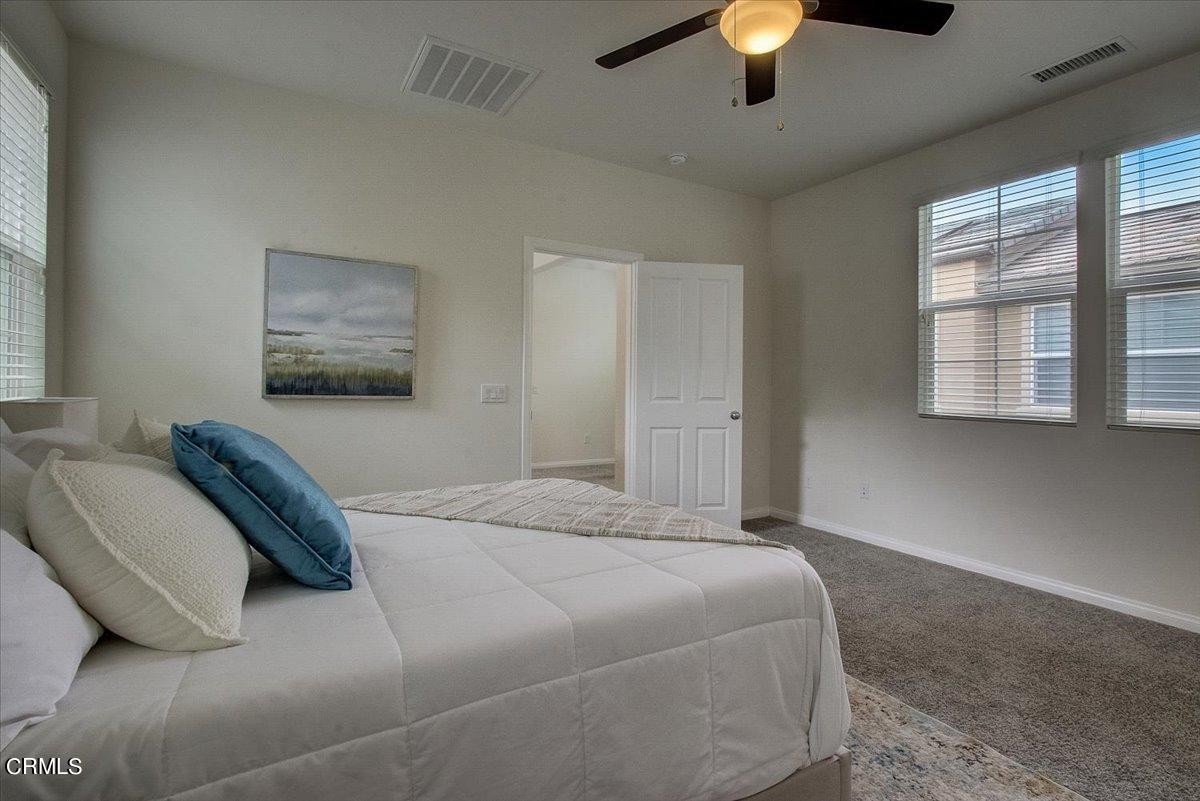 182 Stonegate Road Camarillo, CA 93010 - Photo 29 of 41 a bedroom with a bed and a chandelier