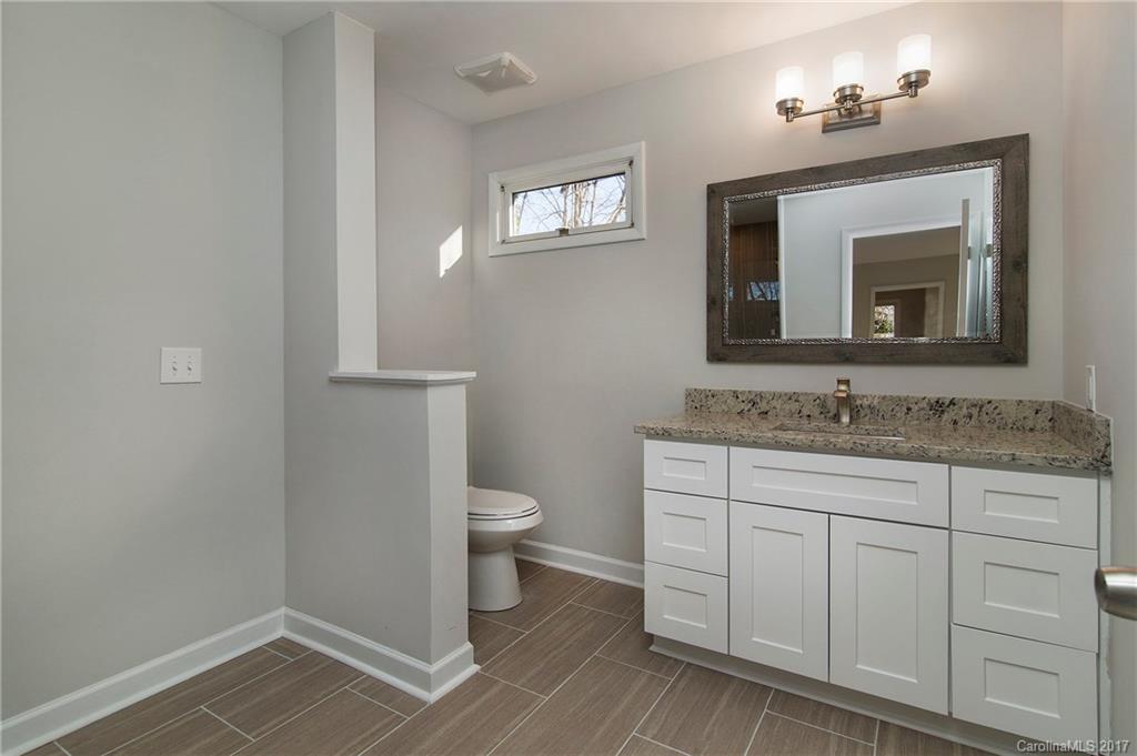4533 Rounding Run Road Charlotte, NC 28277 - Photo 5 of 9 a bathroom with a granite countertop toilet sink and mirror