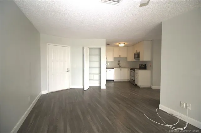 a view of a kitchen with wooden floor and a sink