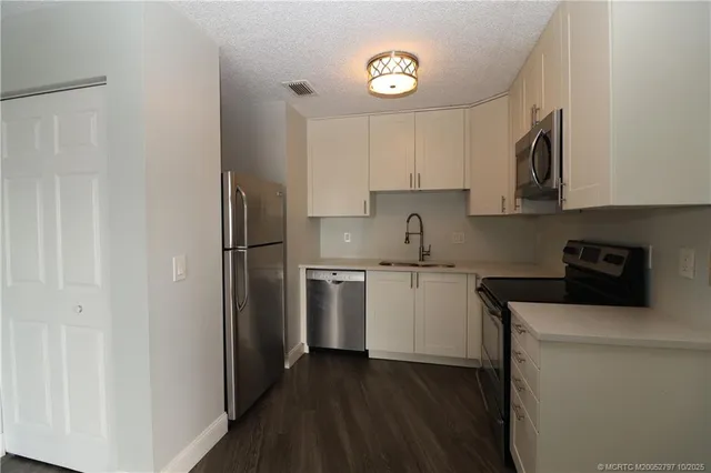 a kitchen with a refrigerator stove and sink