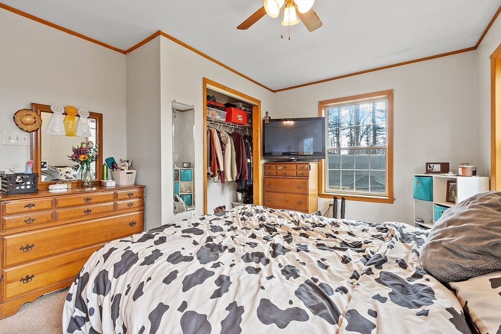 32 East Rindge Road Ashburnham, MA 01430 - Photo 23 of 31 a bedroom with a bed and a dresser next to a window