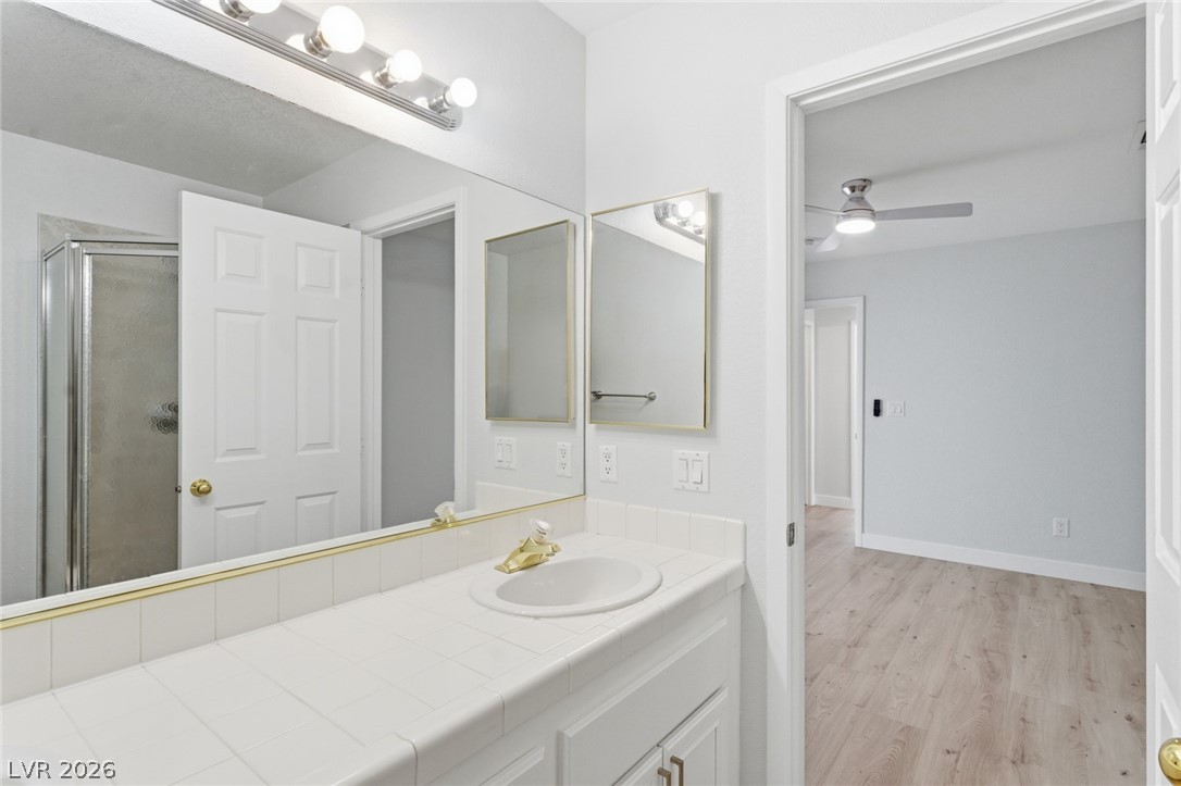 5449 Bugle Way, Unit 104 Las Vegas, NV 89108 - Photo 26 of 33 This clean and inviting bathroom features a single vanity with ample counter space and a sleek shower.