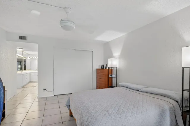 a bedroom with a bed and dresser