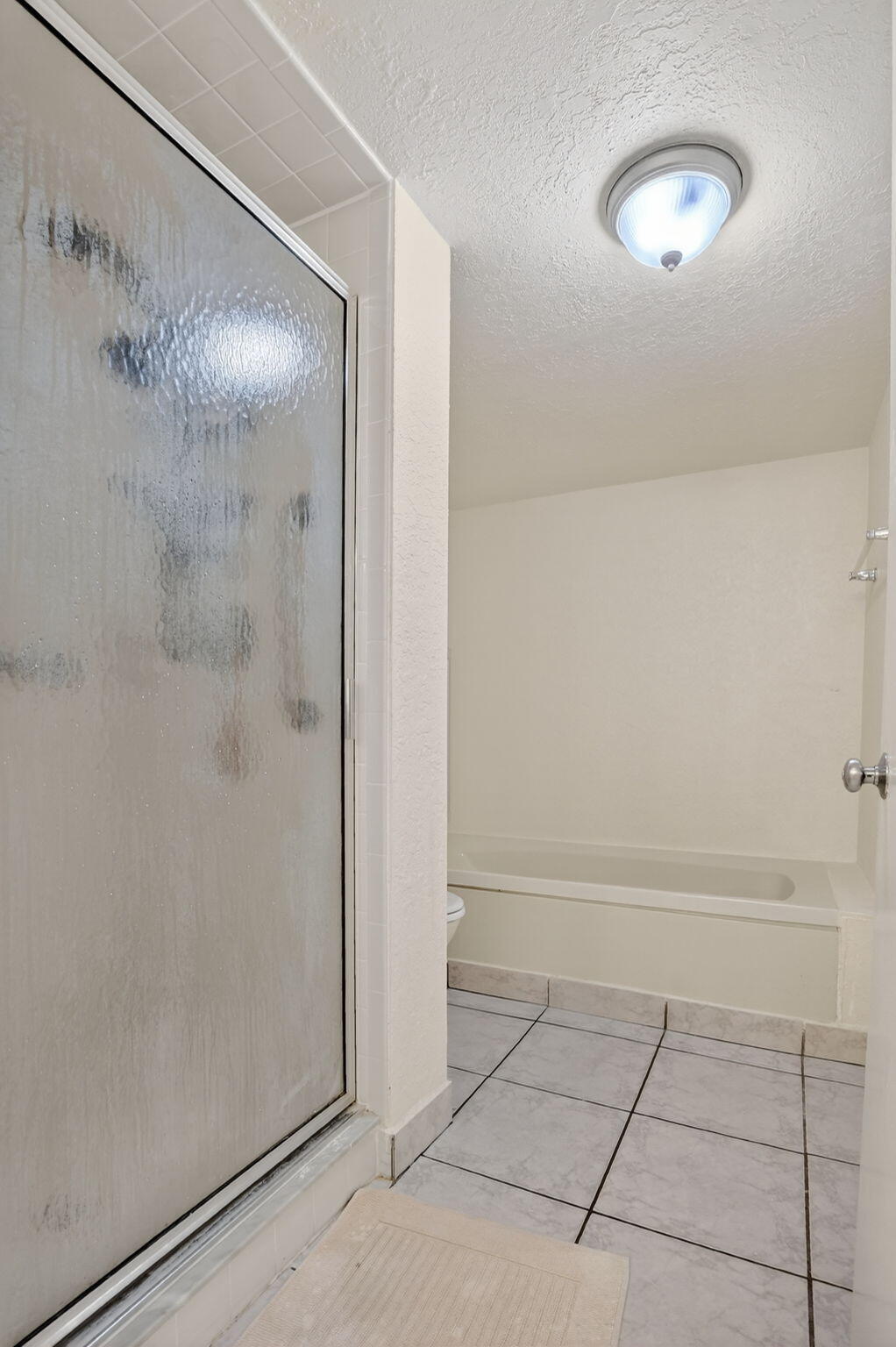 5650 Camino Del Sol, Unit 106 Boca Raton, FL 33433 - Photo 23 of 49 a bathroom with a shower