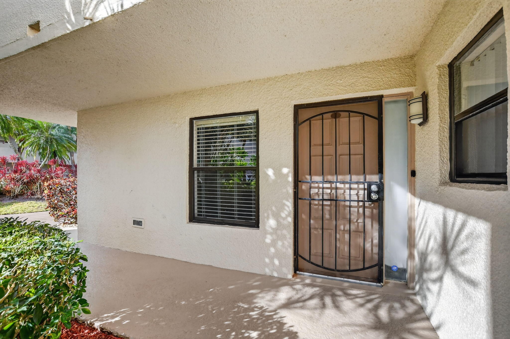 5650 Camino Del Sol, Unit 106 Boca Raton, FL 33433 - Photo 3 of 49 a view of a house with a porch