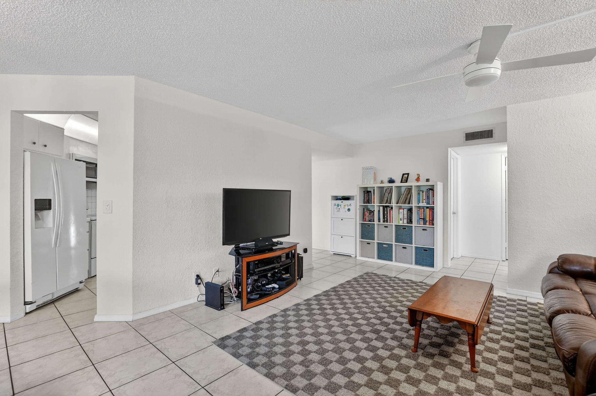 5650 Camino Del Sol, Unit 106 Boca Raton, FL 33433 - Photo 8 of 49 a room with furniture a flat screen tv and rug