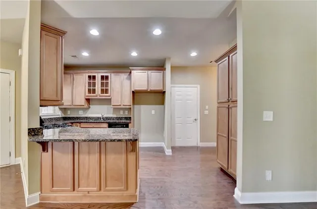 a kitchen with stainless steel appliances granite countertop a sink stove and microwave