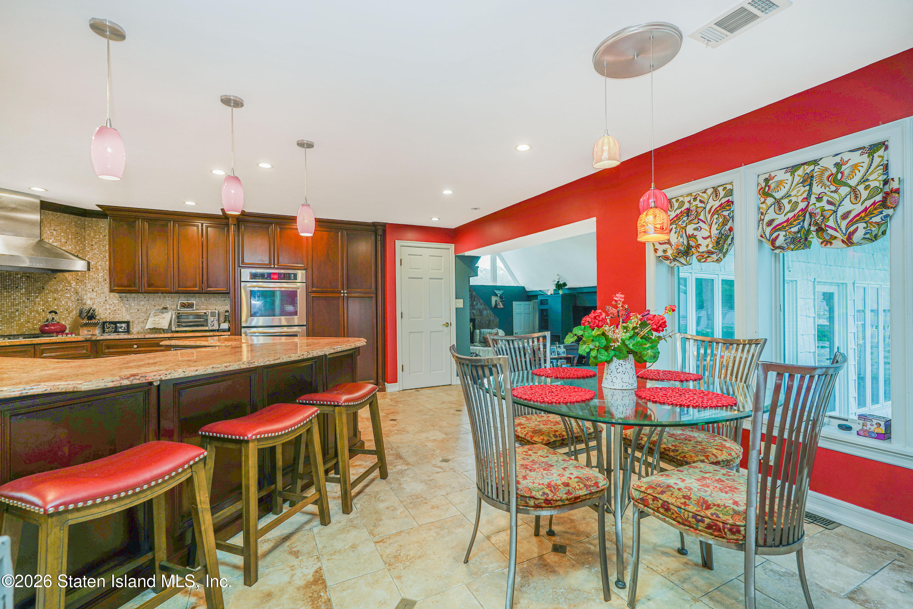 26 Highpoint Road Staten Island, NY 10304 - Photo 14 of 49 a dining room with a table or chairs and a kitchen view
