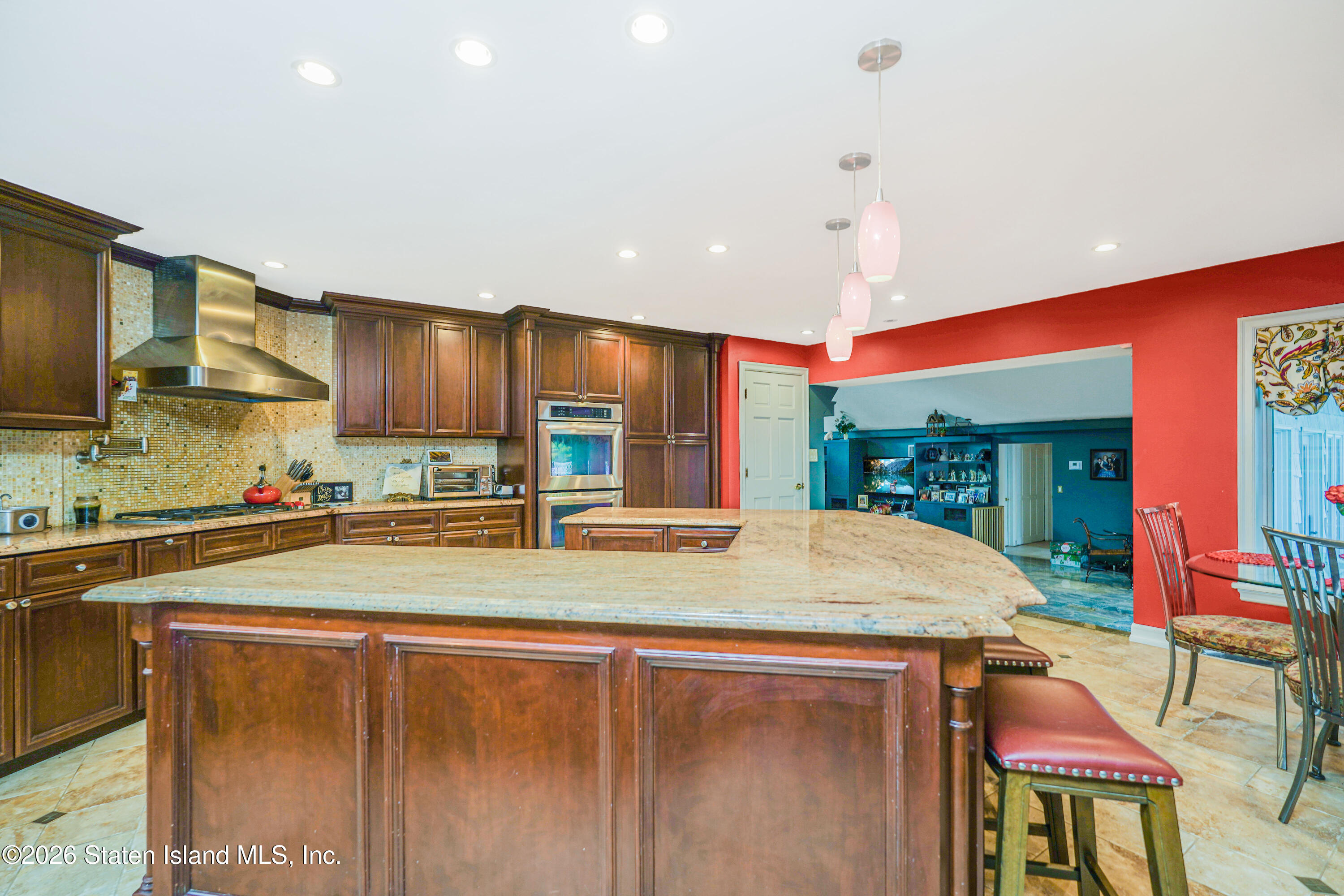26 Highpoint Road Staten Island, NY 10304 - Photo 15 of 49 a kitchen with stainless steel appliances kitchen island granite countertop a sink and cabinets