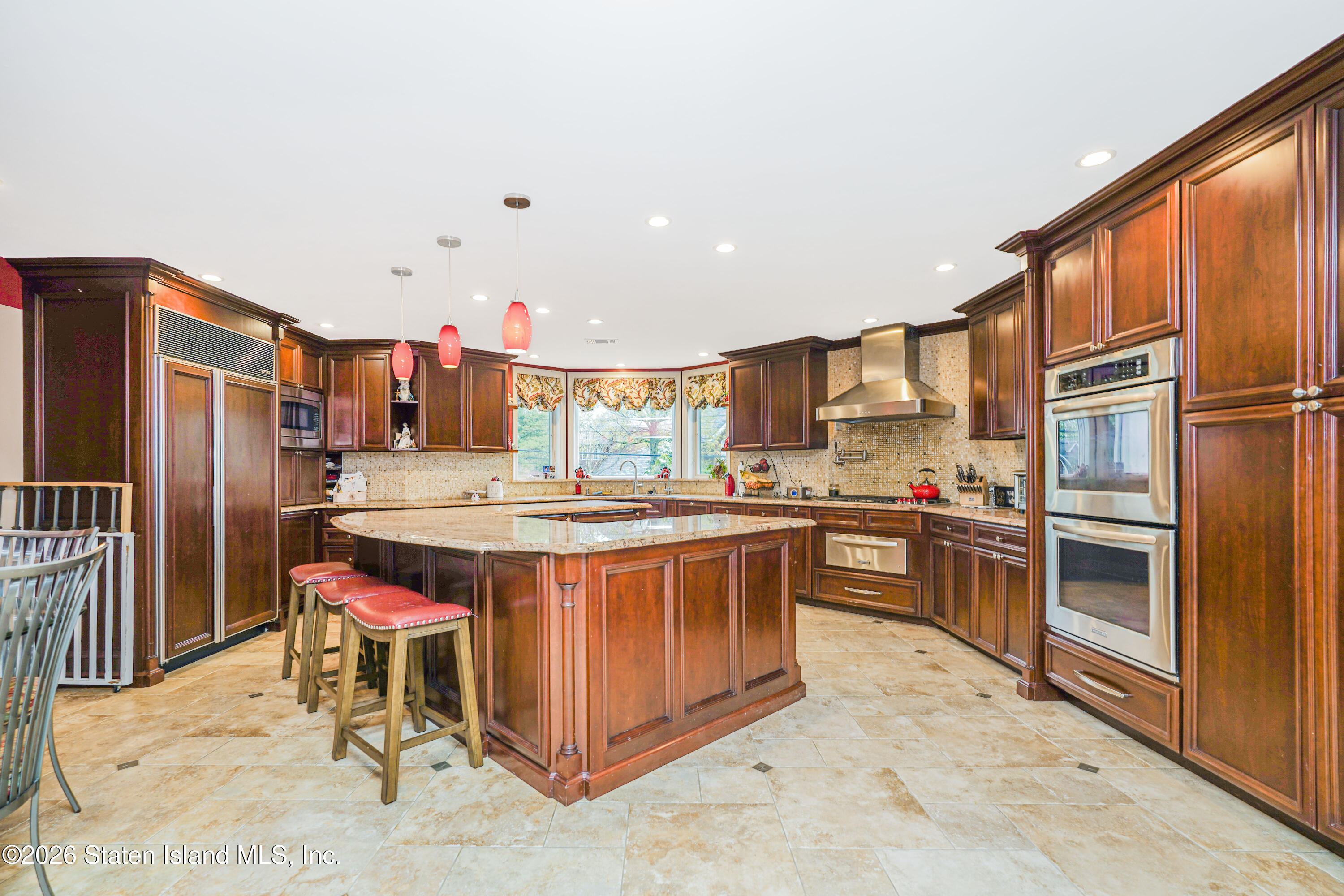 26 Highpoint Road Staten Island, NY 10304 - Photo 16 of 49 a kitchen with stainless steel appliances a stove a sink a refrigerator and cabinets