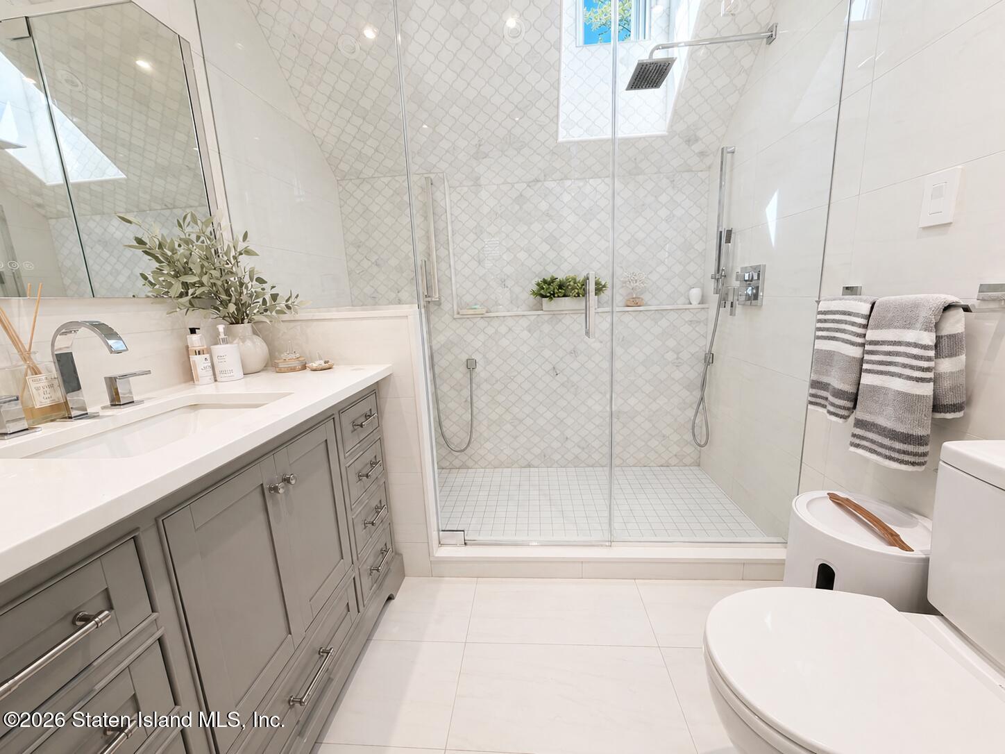26 Highpoint Road Staten Island, NY 10304 - Photo 27 of 49 a bathroom with a double vanity sink toilet and shower