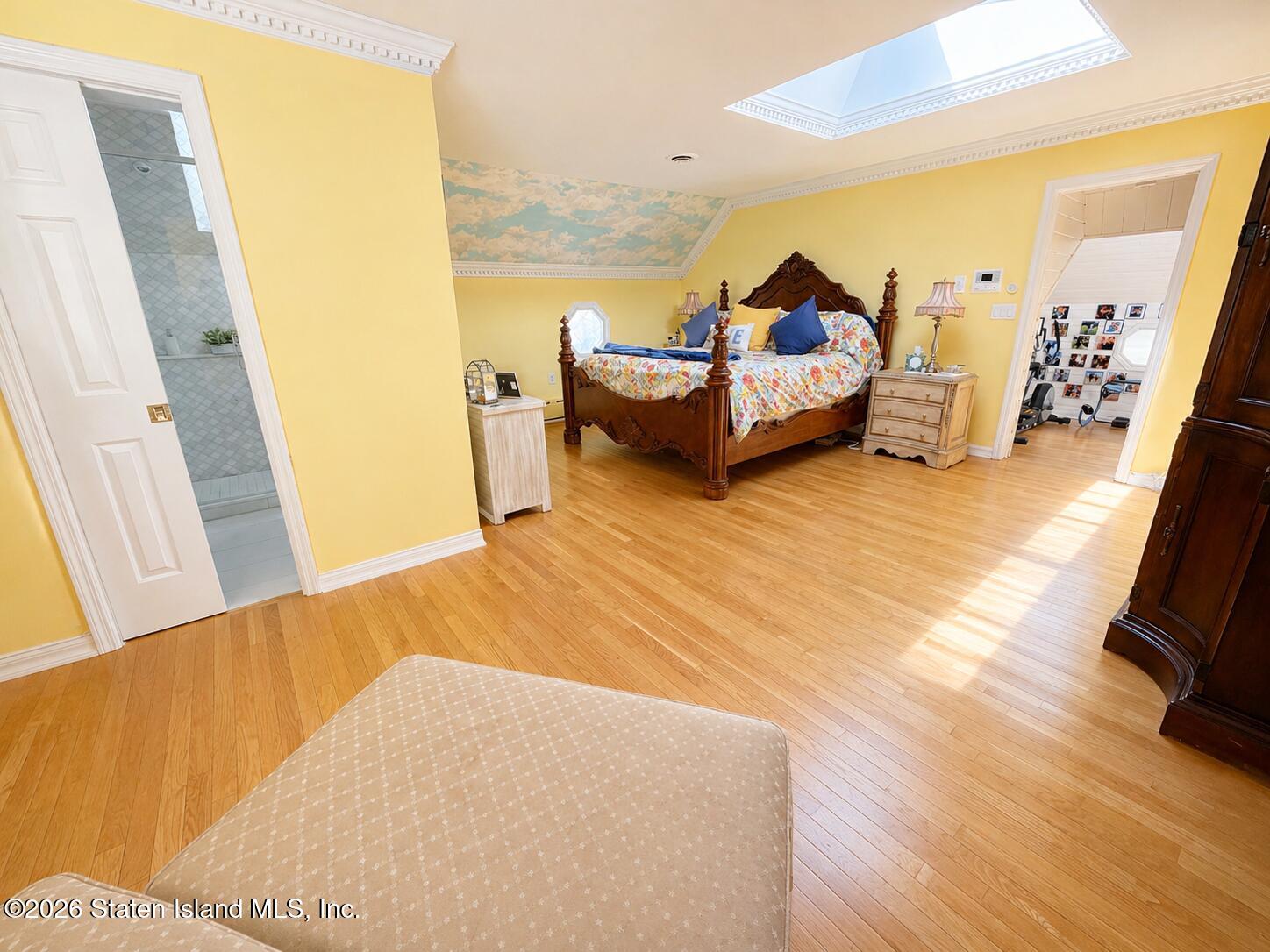 26 Highpoint Road Staten Island, NY 10304 - Photo 28 of 49 a bedroom with a bed and wooden floor