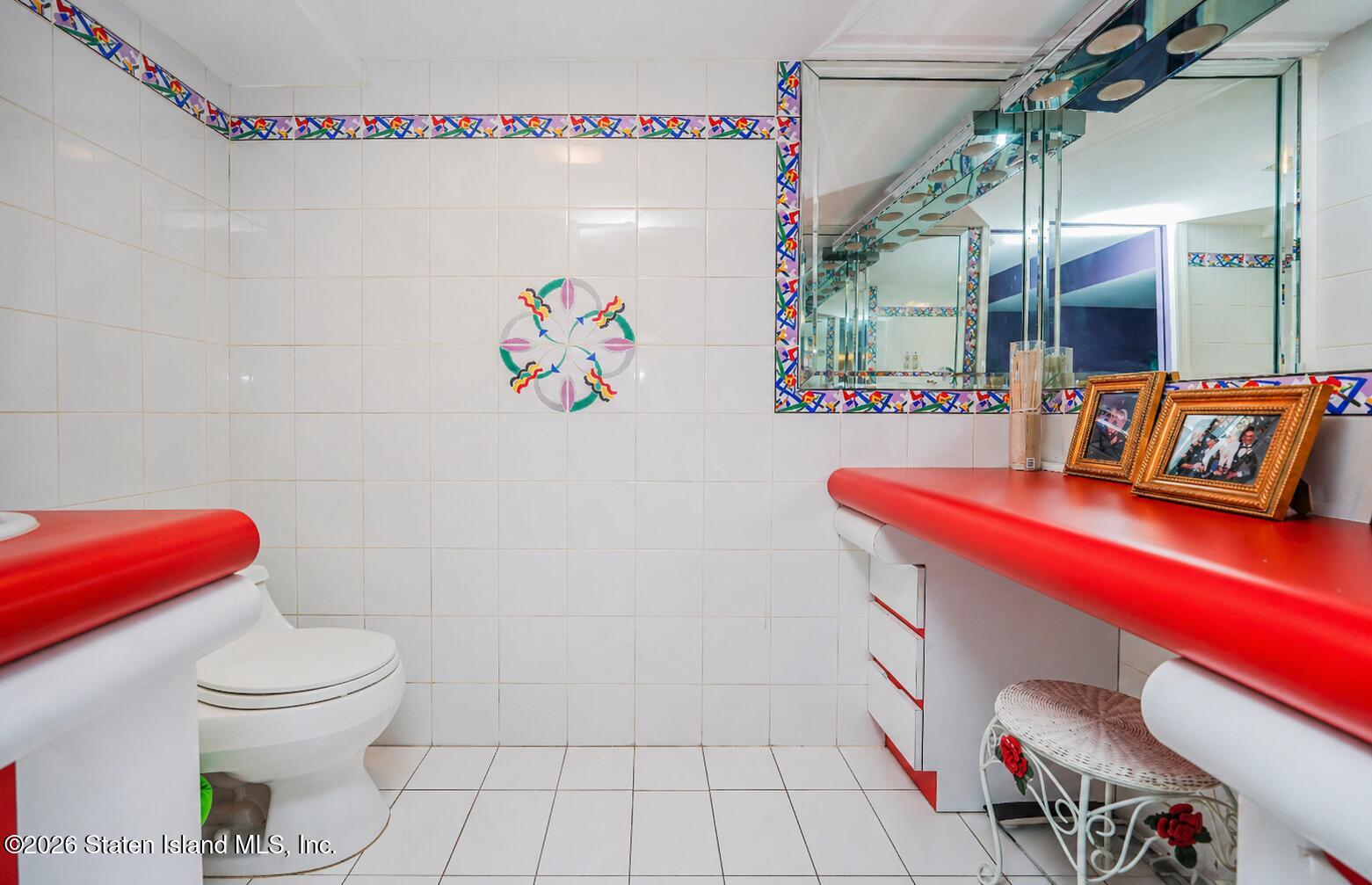 26 Highpoint Road Staten Island, NY 10304 - Photo 33 of 49 a bathroom with a sink a toilet and a shower curtain