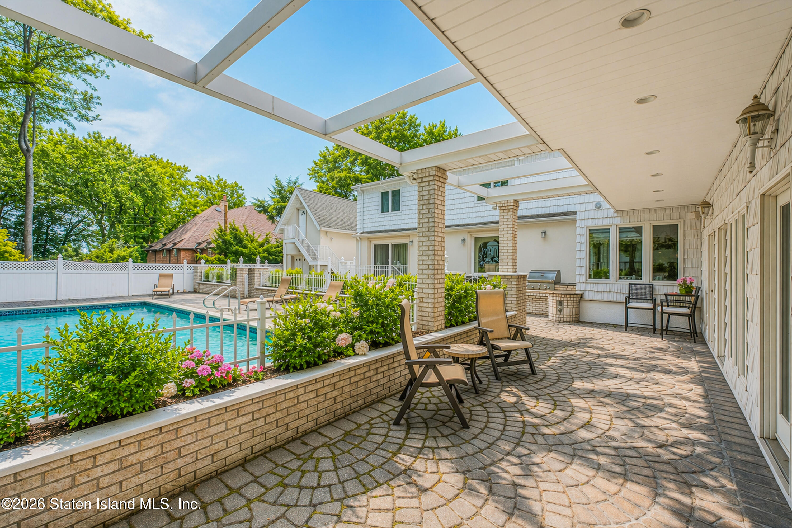 26 Highpoint Road Staten Island, NY 10304 - Photo 39 of 49 a view of a patio with table and chairs and potted plants