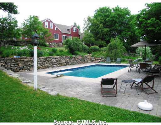 a view of a house with backyard porch and sitting area
