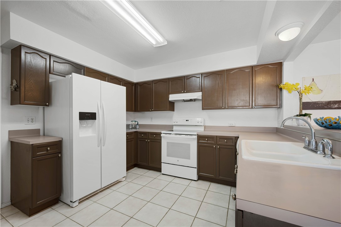 135 Santa Fe Rockport, TX 78382 - Photo 15 of 38 a kitchen with a sink cabinets and stainless steel appliances