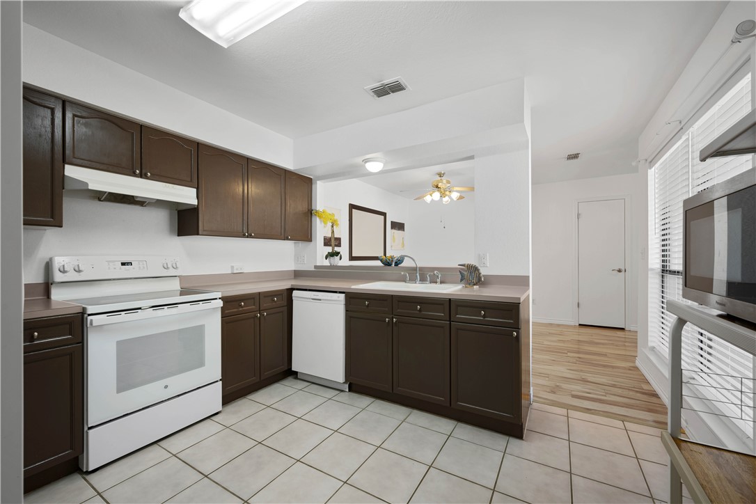 135 Santa Fe Rockport, TX 78382 - Photo 16 of 38 a kitchen with stainless steel appliances granite countertop a sink and cabinets