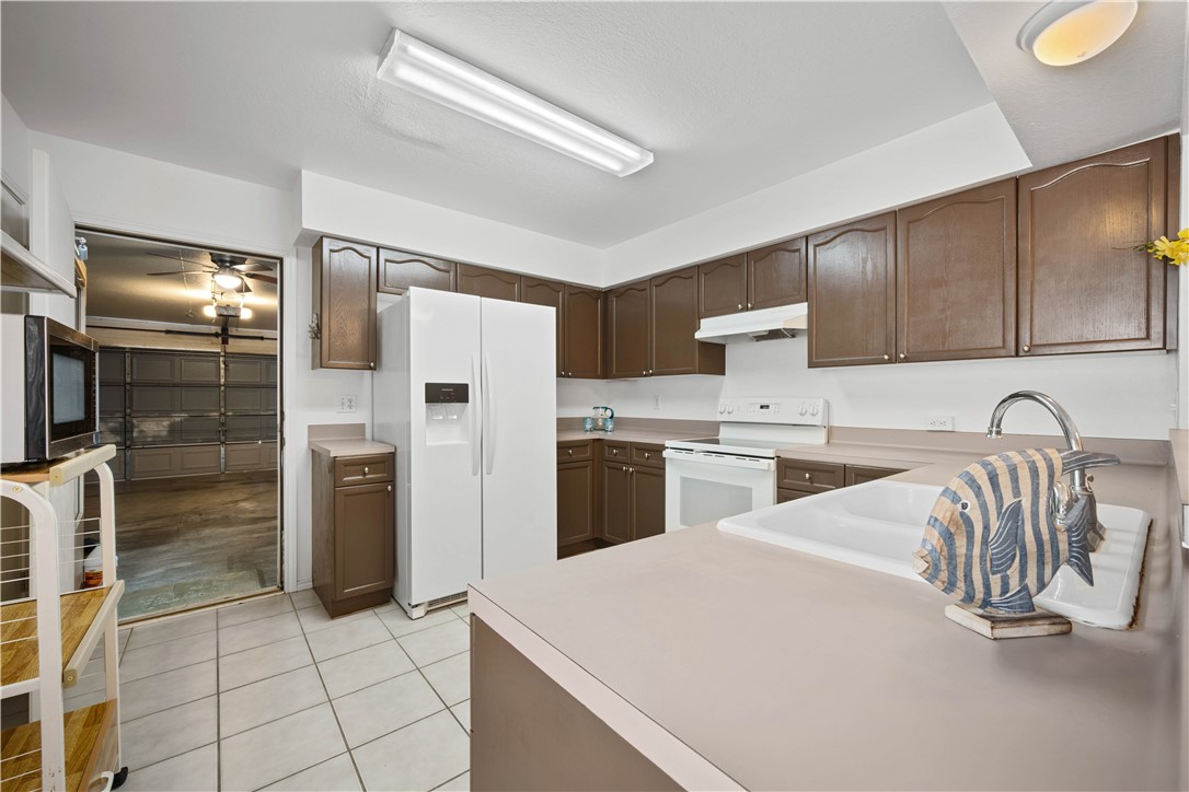 135 Santa Fe Rockport, TX 78382 - Photo 17 of 38 a kitchen with a sink stainless steel appliances and cabinets