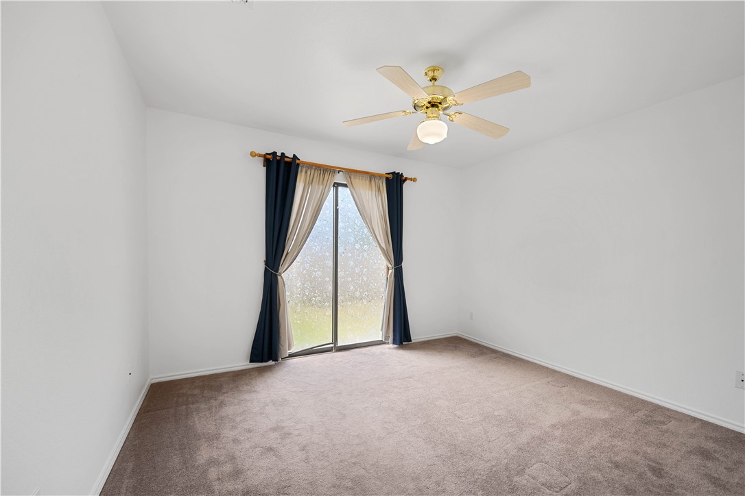135 Santa Fe Rockport, TX 78382 - Photo 20 of 38 a view of an empty room with chandelier fan and a window